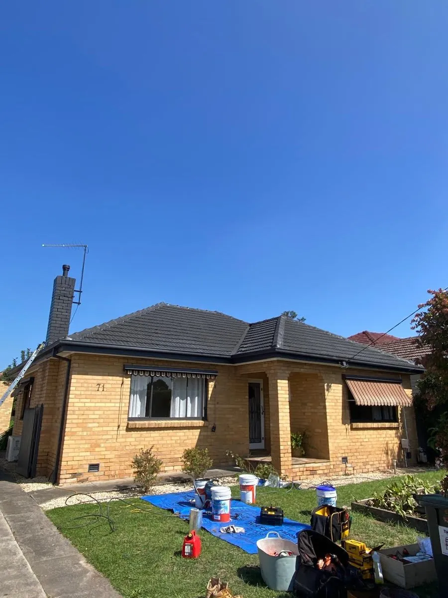 Tiled roofs on Melbourne homes against a blue sky